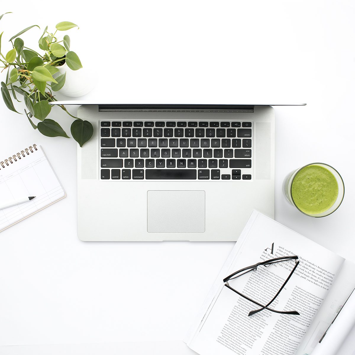 Laptop, notebook and glasses from above
